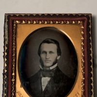 Daguerreotype of man with large square bowtie  stamped Pollack Balto 1.jpg